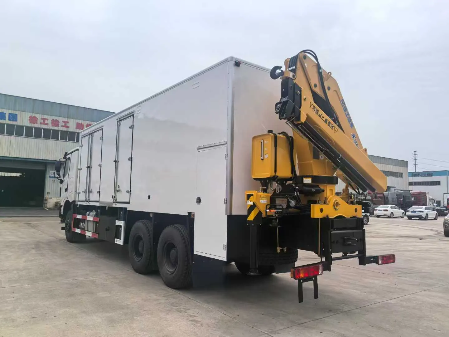 Rear-mounted folding crane
